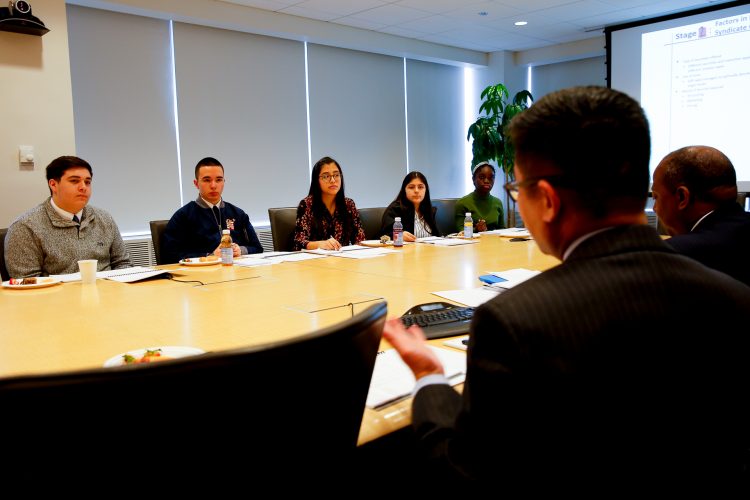 The team at Loop Capital explains the bond exchange process to students. 