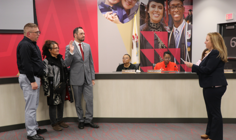 Incumbent member Alex Arroyo sworn in at the Board of Education meeting. 