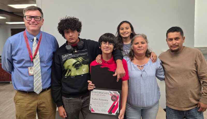 Yahir Ferreira with family and Fred Rogers Magnet Academy Principal Brian Valek