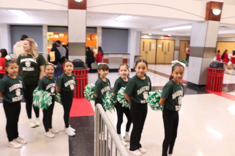 Cheerleaders get ready to begin their performance. 