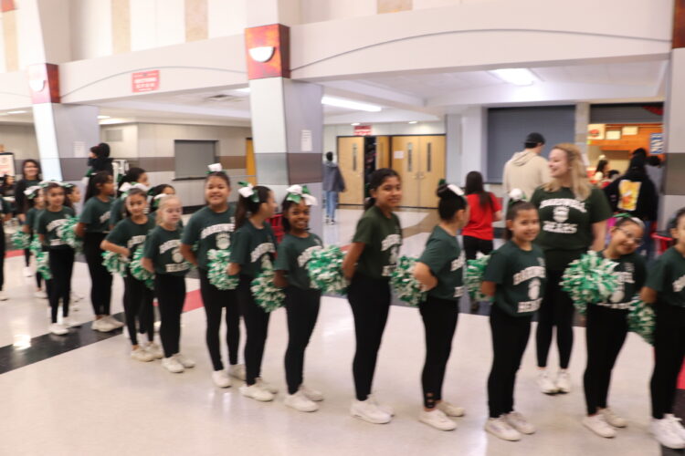 Cheerleaders get ready to begin their performance. 