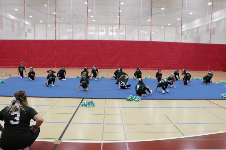 Cheerleaders practice their routine before the tournament.