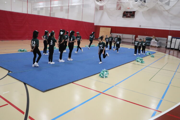 Cheerleaders practice their routine before the tournament.