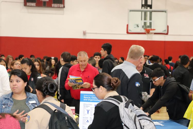 East High teachers help students through the college fair.