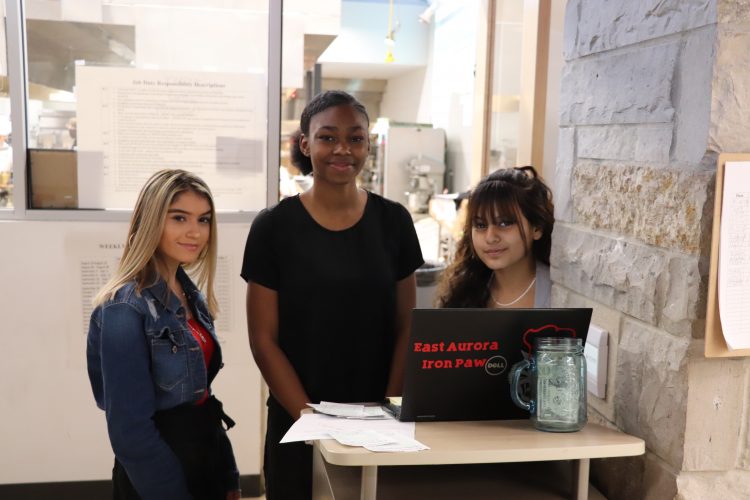 Students ready to serve lunch to staff.